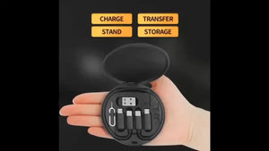 Black portable charging station held in a hand with text 'Charge', 'Stand', 'Transfer', 'Storage' on a dark background