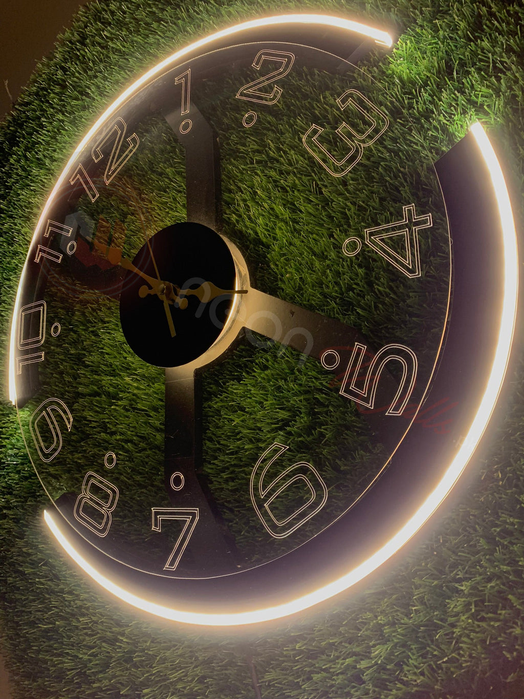 Close-up of a clock face with grass background