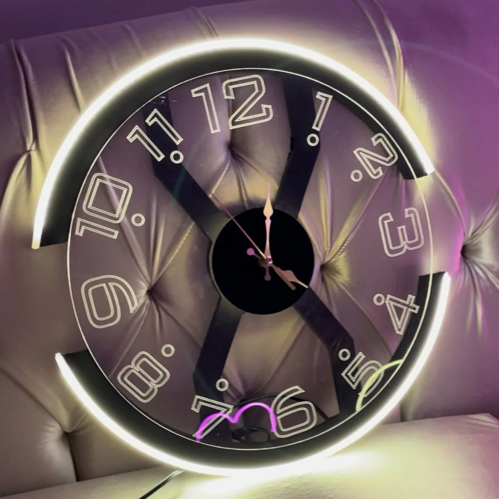 Decorative clock with glowing edge on a purple cushioned surface