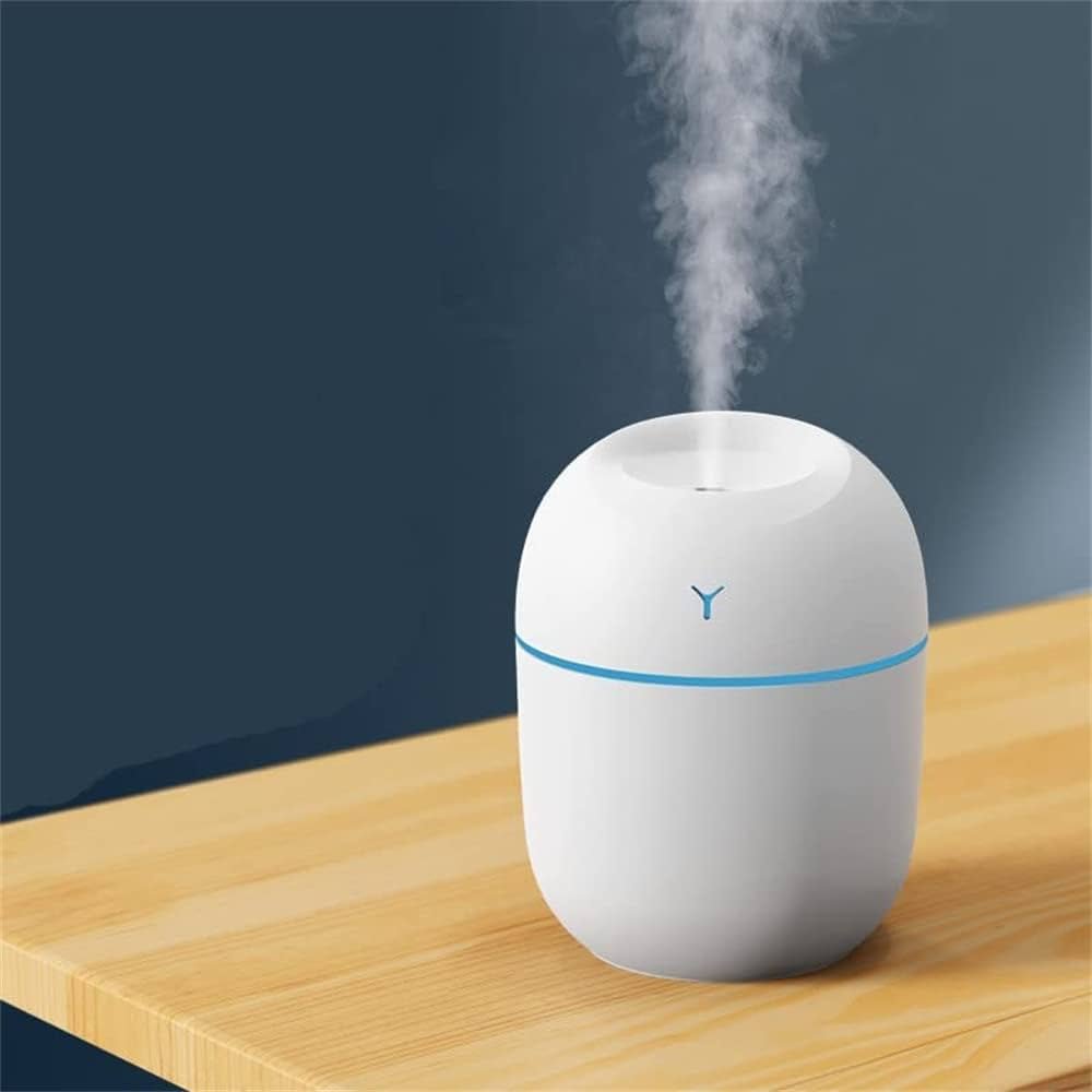 White humidifier with blue light on a wooden surface against a dark background