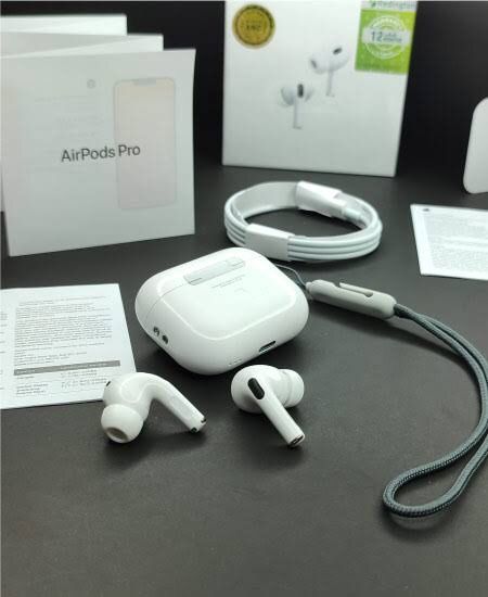 Apple AirPods Pro with charging case and accessories on a dark surface