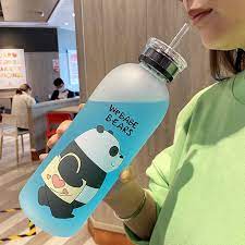 Person holding a panda-themed water bottle with text in an indoor setting